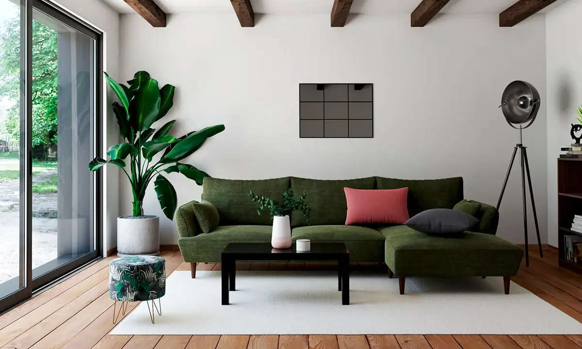 Un salon moderne avec un canapé vert, une table basse noire et un pouf décoré de feuilles tropicales. Quel meuble devant baie vitrée ? Le pouf, parfait pour un coin lecture.