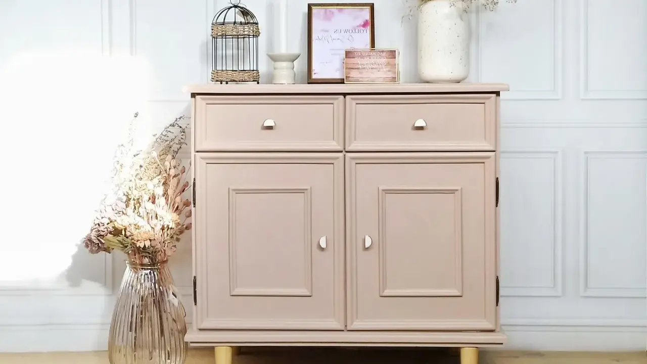 Meuble en bois repeint en rose poudré, une belle idée de couleur pour un relooking. Décoré avec des fleurs séchées et une cage décorative.