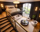 Élégante chambre mezzanine avec un lit douillet en hauteur, un salon cosy en contrebas et un escalier en bois menant à cet espace unique.