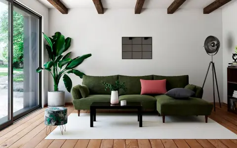 Un salon moderne avec un canapé vert, une table basse noire et un pouf décoré de feuilles tropicales. Quel meuble devant baie vitrée ? Le pouf, parfait pour un coin lecture.