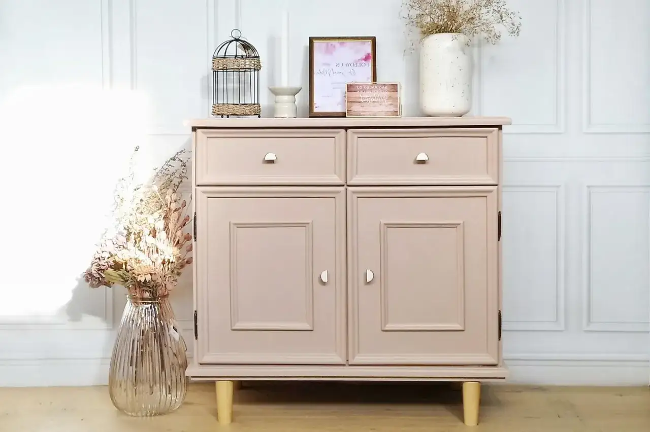Meuble en bois repeint en rose poudré, une belle idée de couleur pour un relooking. Décoré avec des fleurs séchées et une cage décorative.