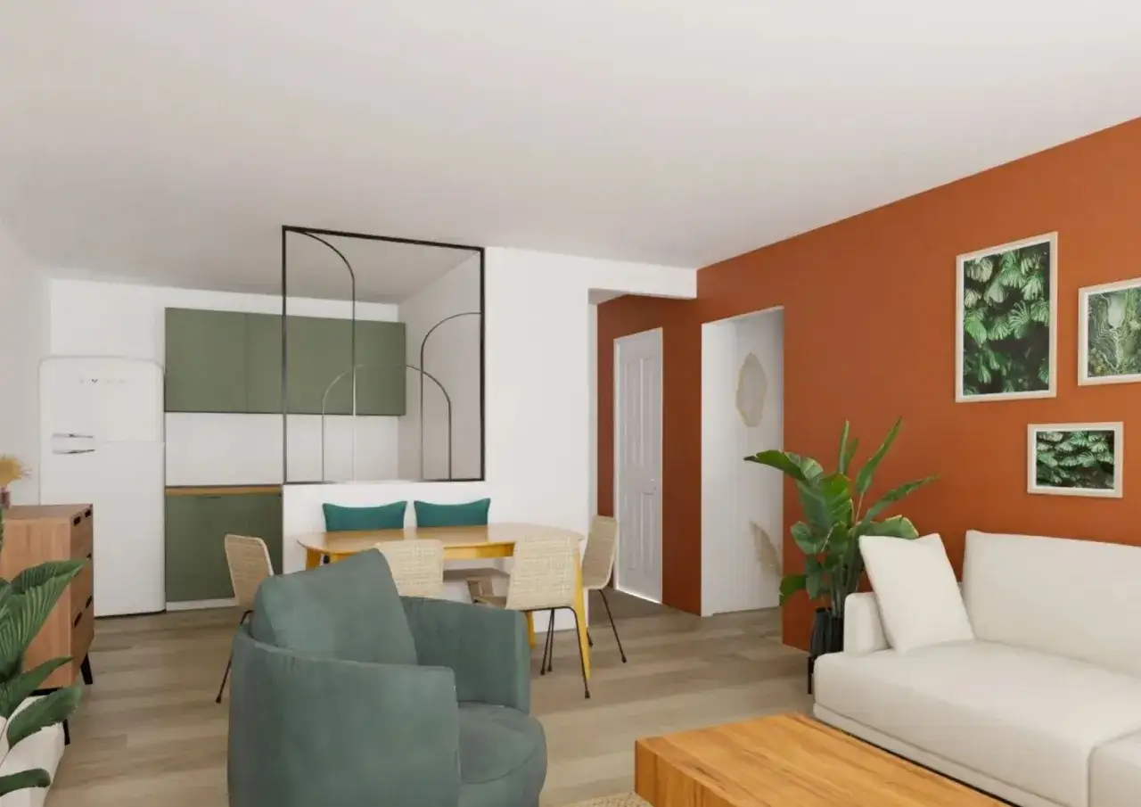 Un salon moderne avec un mur orange vif. Le vert clair des armoires de cuisine et du fauteuil se marie bien avec cette couleur.