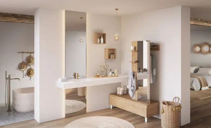 Salle de bain lumineuse avec baignoire, double vasque et dressing, créant une ambiance de suite parentale épurée et naturelle.